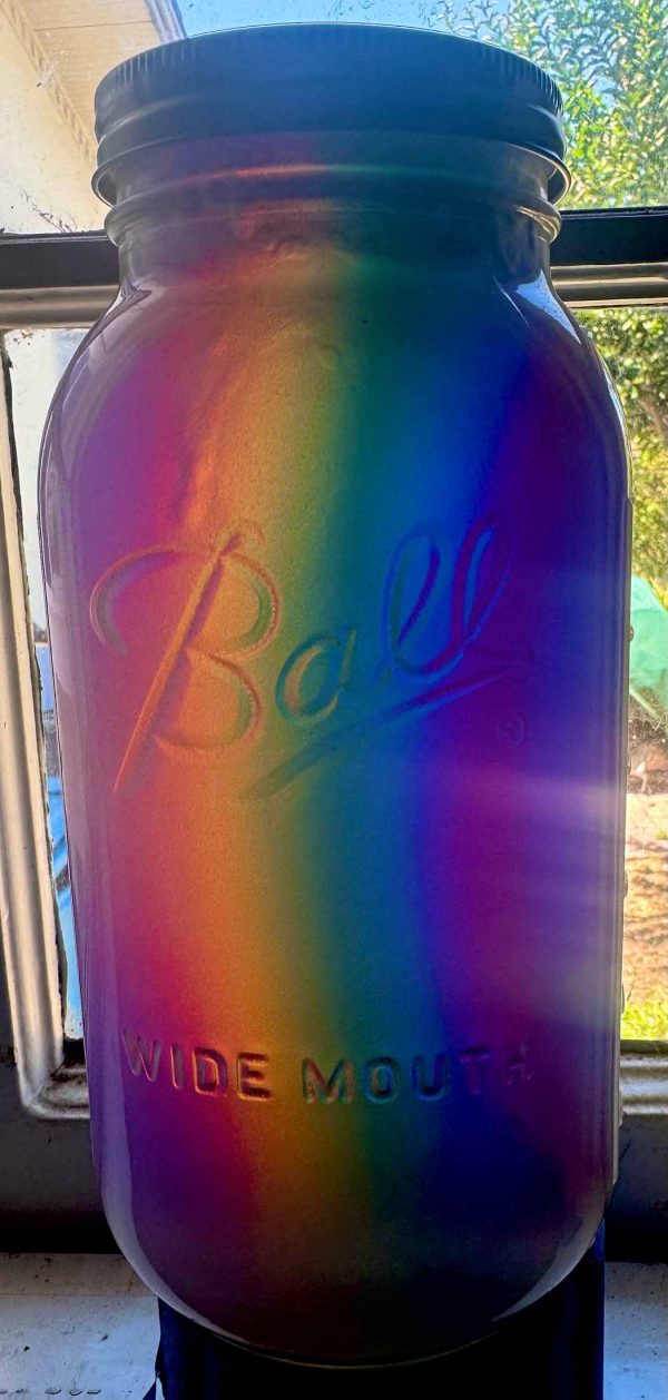 A mason Jar with a Rainbow of "Cosmic Jelly" inside